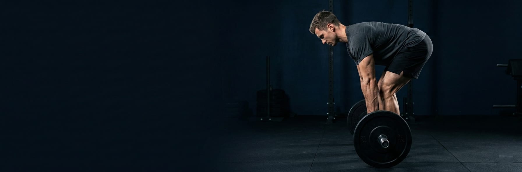 Perfect squat form in side view — dramatic rim lighting tracing muscle definition and spine alignment